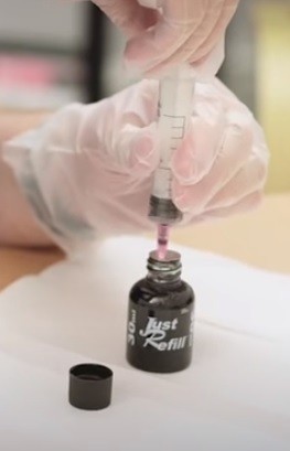 How To Refill Office Printer Cartridges: use the string to draw out some ink